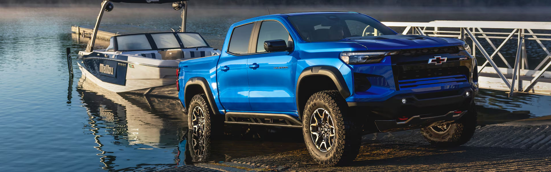 Chevrolet Silverado parked on a dock, showcasing its sleek design and sturdy build against a waterfront backdrop.