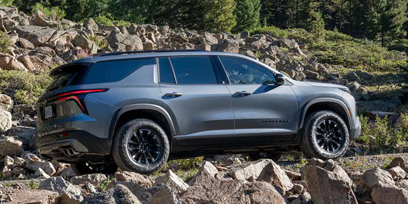Chevrolet Traverse, a rugged SUV, showcasing its bold design and off-road capabilities in a scenic outdoor setting.
